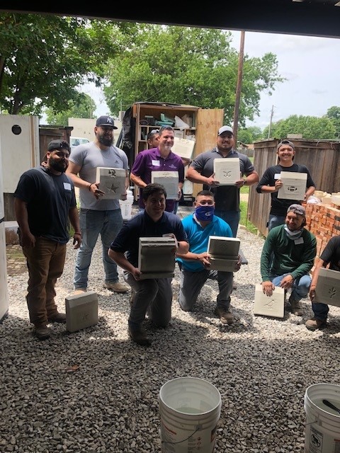 Student show their repaired concrete blocks after class.