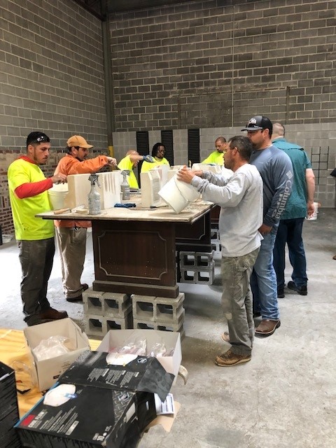 Students apply the 
 mixture to concrete samples