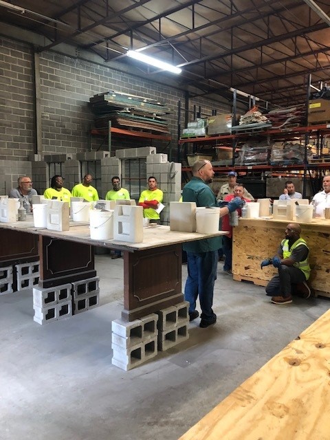 Preparing the classroom with buckets of example materials.