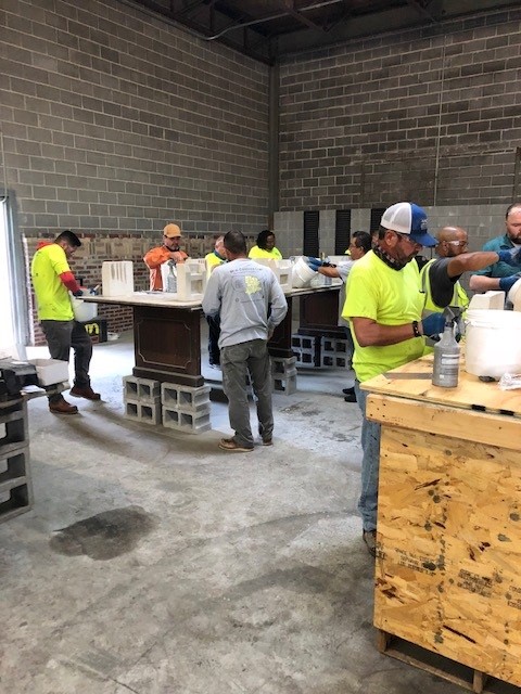 Students in the classroom mix the ingredients in buckets